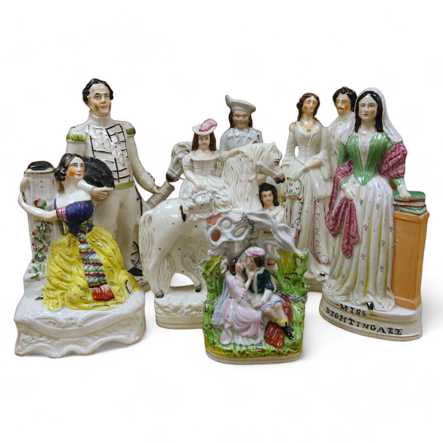 Staffordshire pottery: a bocage group, 25.5cm, 'Huntsman' 40.5cm, figure with child groom 40.5cm, figure of girl beside a column 30cm, George and Eliza Harris, 36cm, 'Dundas' beside a cannon, 40.5cm, gentleman and lady h